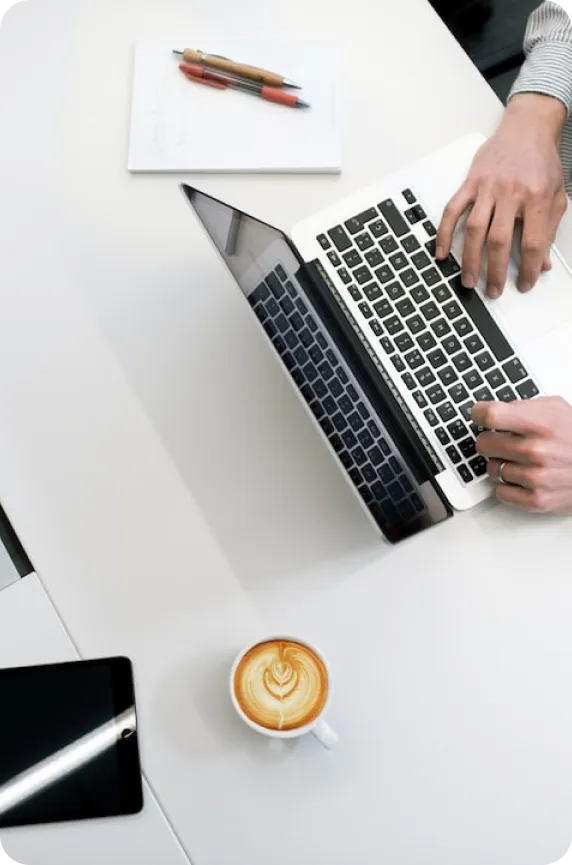 A top-down view on a person working on a laptop.